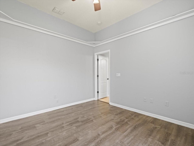 empty room featuring ceiling fan and wood-type flooring