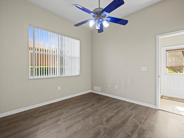 empty room with ceiling fan and dark hardwood / wood-style floors