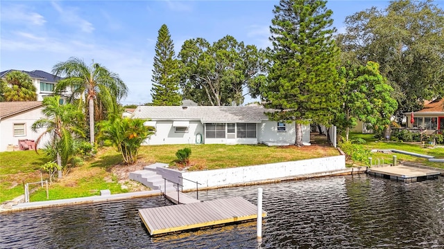 view of dock featuring a yard and a water view