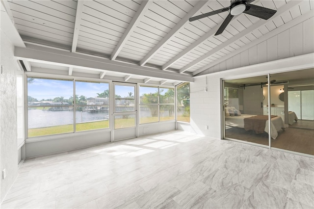 unfurnished sunroom featuring vaulted ceiling with beams, ceiling fan, and a water view