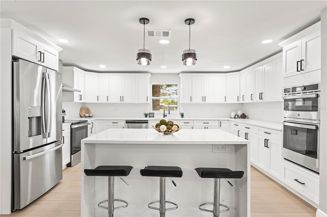 kitchen featuring a center island, light hardwood / wood-style floors, and stainless steel appliances