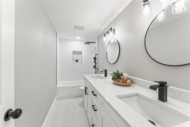 full bathroom with tile patterned flooring, vanity, toilet, and tiled shower / bath combo