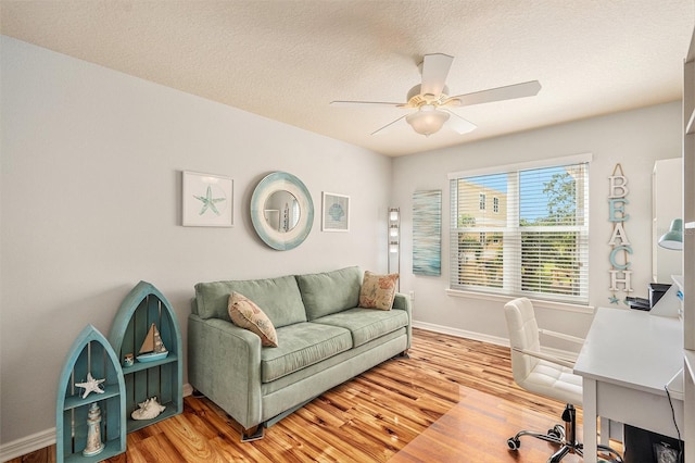 home office with hardwood / wood-style floors, a textured ceiling, and ceiling fan