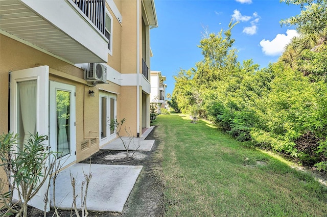 view of yard with ac unit and french doors