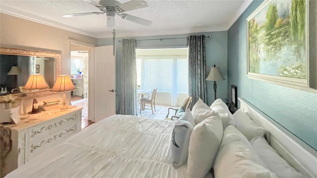 bedroom with ceiling fan and a textured ceiling