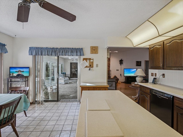 kitchen with ceiling fan, dishwasher, light tile patterned flooring, and dark brown cabinets