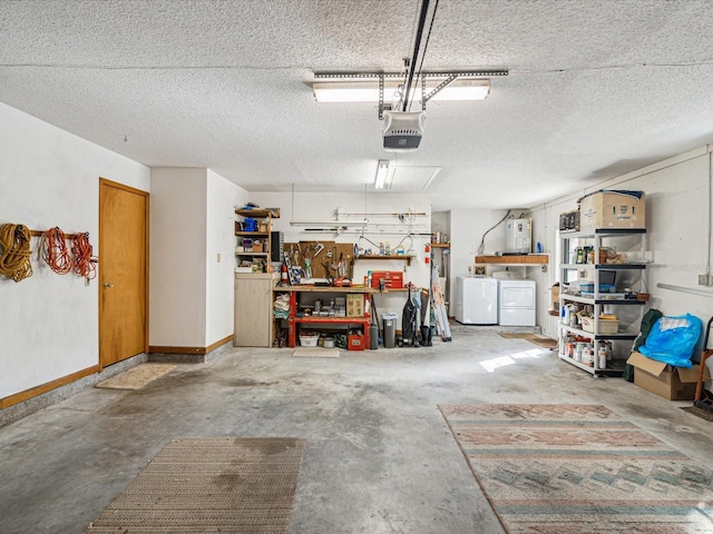 garage with a workshop area, electric water heater, a garage door opener, and washing machine and dryer