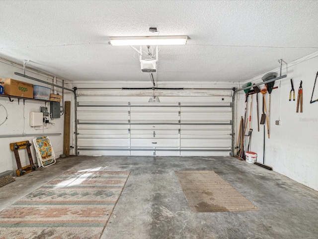 garage featuring electric panel and a garage door opener