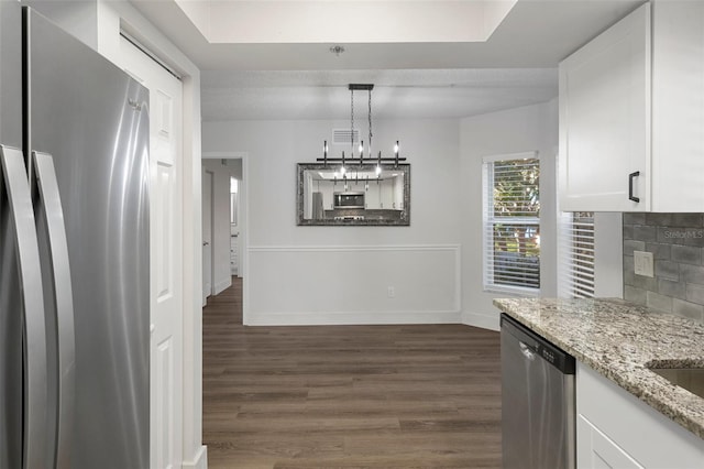 unfurnished dining area with a notable chandelier and dark wood-type flooring