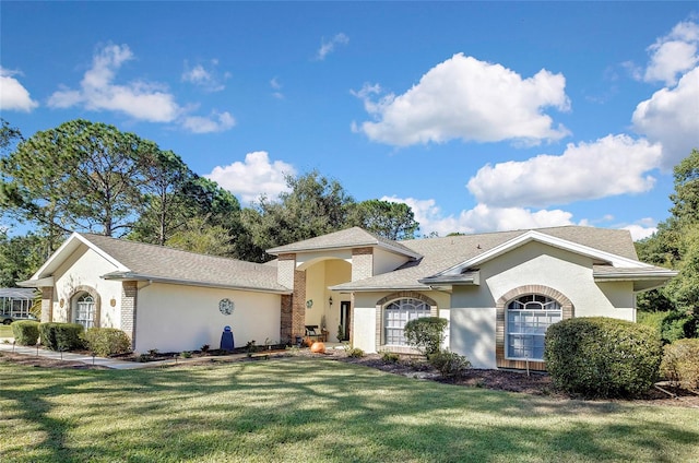 ranch-style home with a front lawn