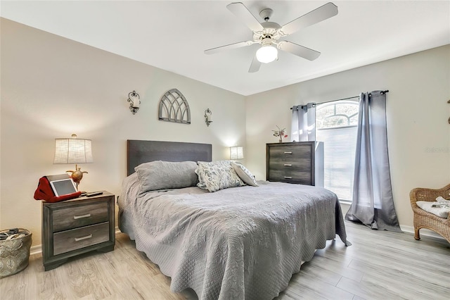 bedroom with ceiling fan and light hardwood / wood-style floors