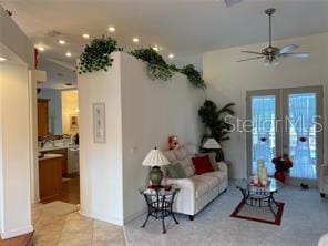 living room with ceiling fan, light tile patterned floors, and french doors