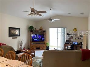 living room featuring ceiling fan and lofted ceiling