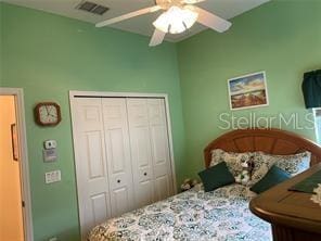 bedroom with ceiling fan and a closet