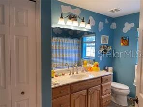 bathroom featuring vanity and toilet