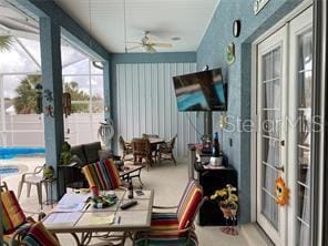 sunroom with ceiling fan and french doors