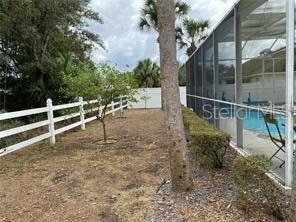 view of yard featuring a lanai and a fenced in pool