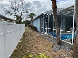 view of side of home featuring a lanai