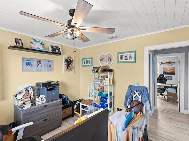 bedroom with ceiling fan, crown molding, and light hardwood / wood-style flooring