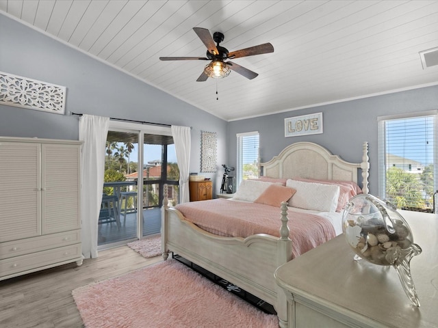 bedroom with access to exterior, light hardwood / wood-style floors, multiple windows, and ceiling fan