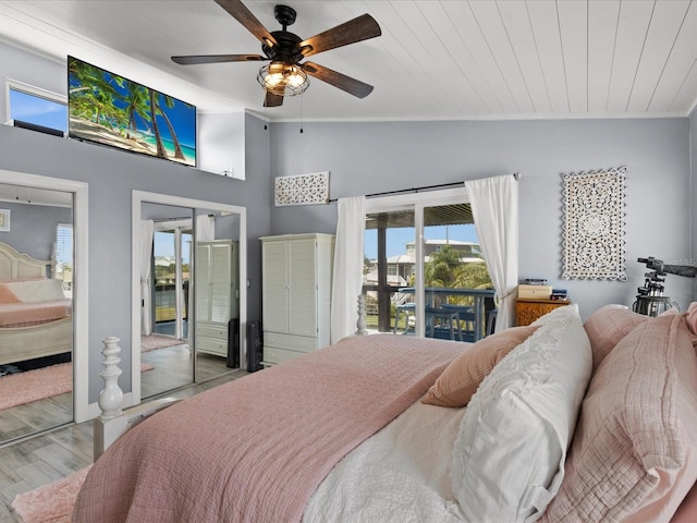 bedroom featuring light wood-type flooring, access to outside, ceiling fan, crown molding, and lofted ceiling