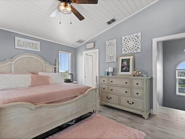 bedroom featuring light wood-type flooring, multiple windows, wooden ceiling, and ceiling fan