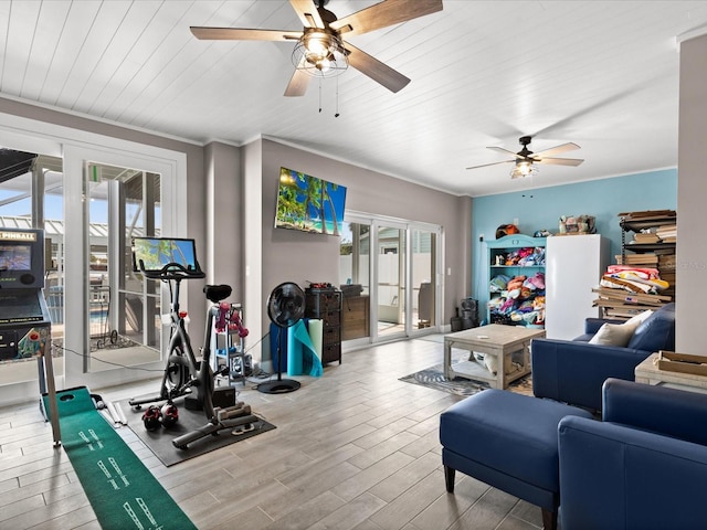 exercise room with plenty of natural light, light hardwood / wood-style floors, french doors, and ornamental molding