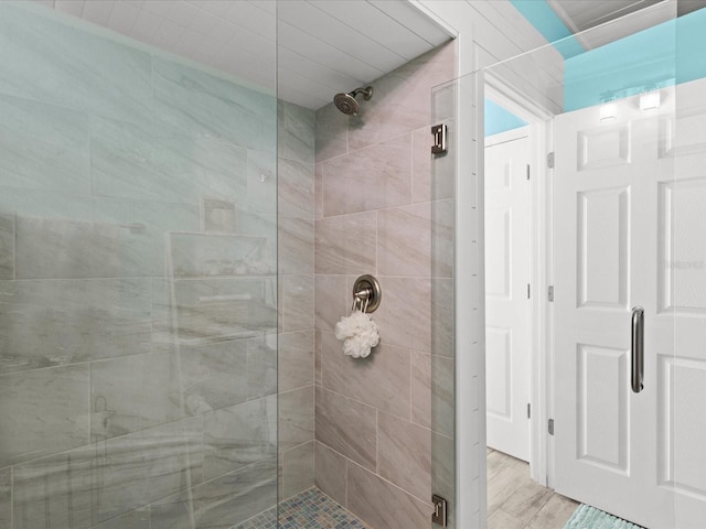 bathroom featuring hardwood / wood-style floors and walk in shower