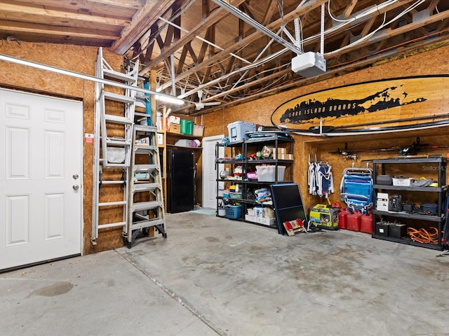 garage with black fridge and a garage door opener