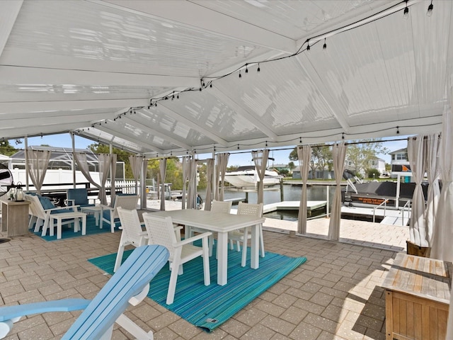 sunroom / solarium featuring a water view and lofted ceiling