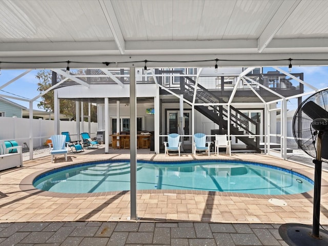 view of pool featuring exterior bar and a patio area