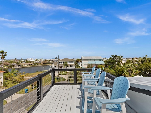 wooden terrace featuring a water view