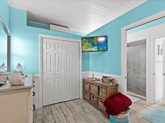 bathroom with hardwood / wood-style floors and an enclosed shower