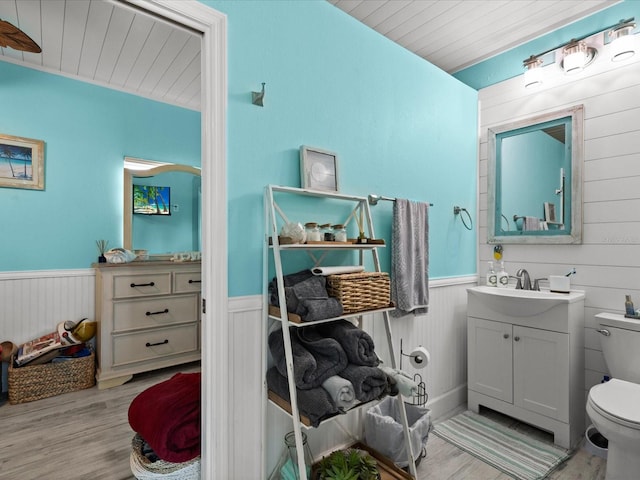 bathroom with toilet, vanity, wooden ceiling, and hardwood / wood-style flooring