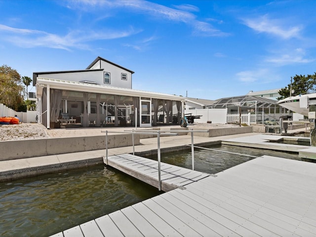 dock area featuring a water view and a patio