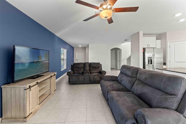 tiled living room with ceiling fan