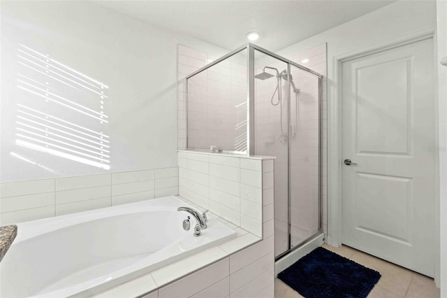 bathroom with tile patterned floors and plus walk in shower