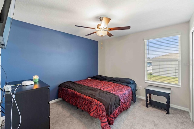 bedroom with ceiling fan and light colored carpet