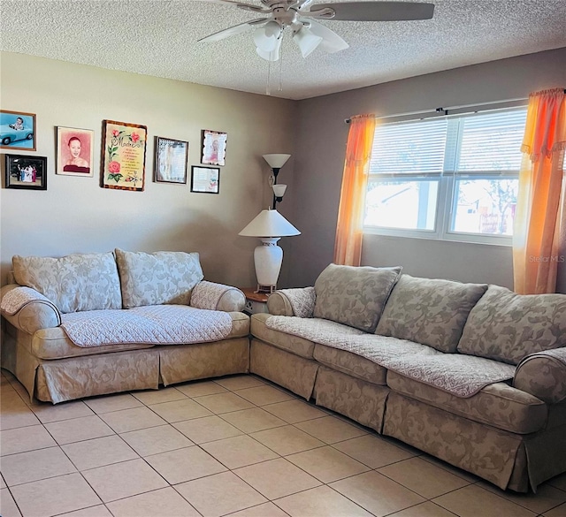 tiled living room featuring ceiling fan and a textured ceiling