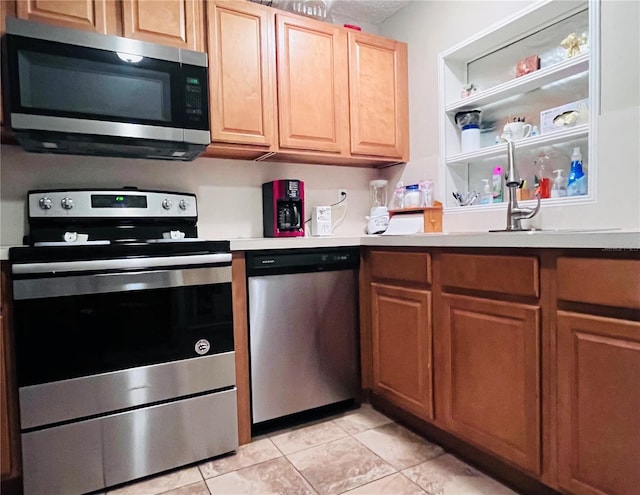 kitchen featuring appliances with stainless steel finishes and light tile patterned floors