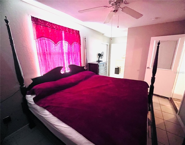 tiled bedroom featuring ceiling fan