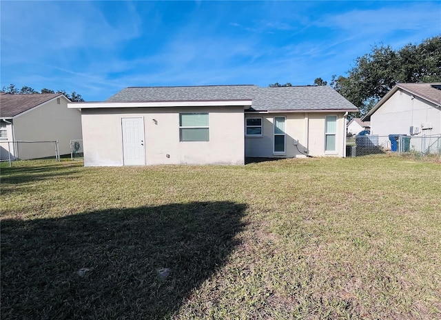 rear view of house featuring a lawn