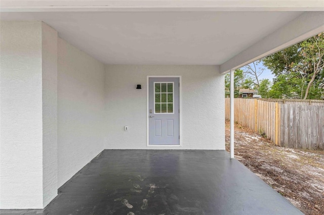 view of exterior entry with a patio