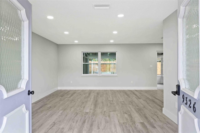 unfurnished room with light hardwood / wood-style flooring