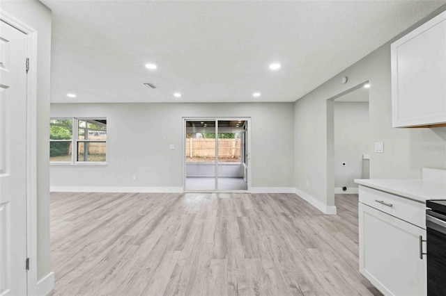 unfurnished living room featuring light wood-type flooring