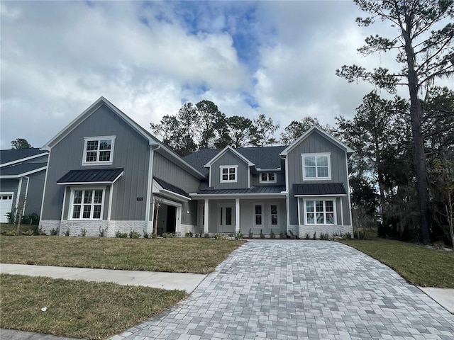 craftsman-style house with a porch and a front lawn