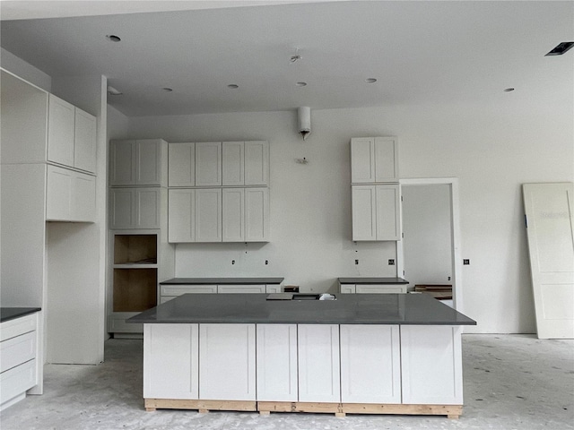 kitchen with white cabinetry and a kitchen island