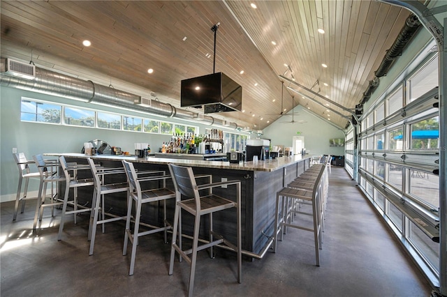 bar with pendant lighting, lofted ceiling, light stone counters, and wooden ceiling