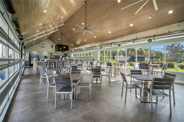 dining room with ceiling fan, concrete floors, high vaulted ceiling, and wood ceiling