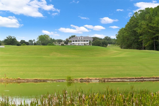 surrounding community featuring a water view and a lawn